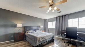 A bedroom with a bed, nightstands, a desk, and a ceiling fan. - Georgetown Gem 💎 (Georgetown)