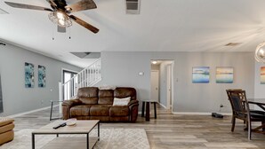 A spacious living room with a leather sofa, a coffee table, and a dining area with a wooden table and chairs. - Georgetown Gem 💎 (Georgetown)