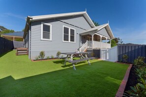 A two-story house with a covered porch and a well-maintained lawn. - Luxury Villa With Gorgeous Views, We Sleep 11 (Marysville)