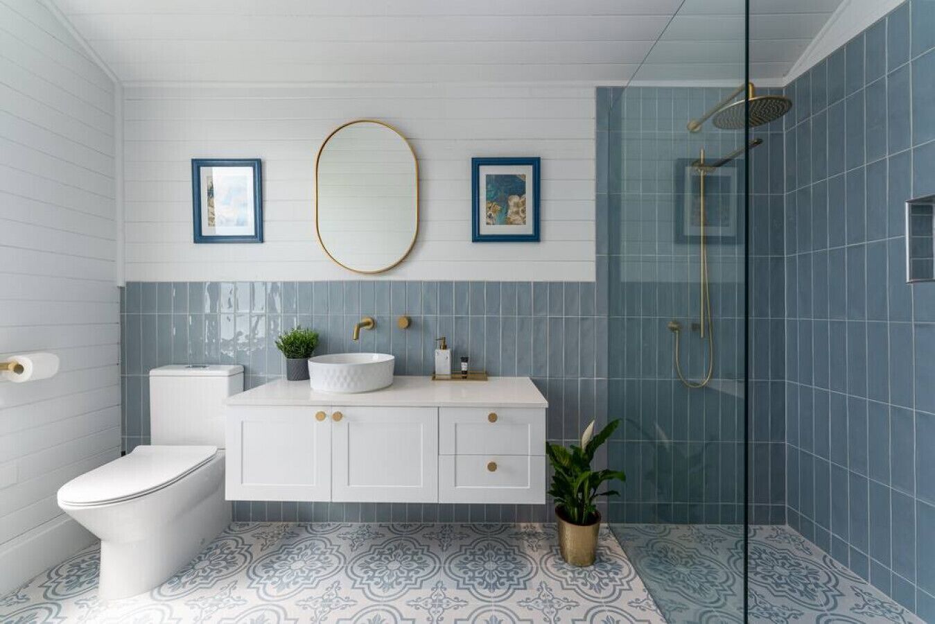 A bathroom with a toilet, sink, and shower.