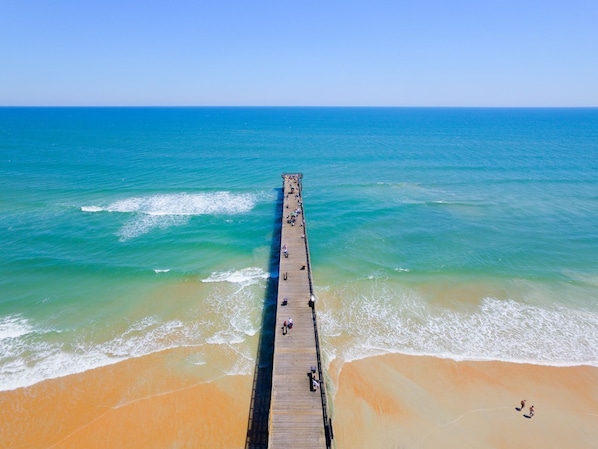 Guests can enjoy a tranquil beach setting with a long pier and stunning ocean views.