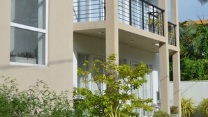 A multi-story building with balconies, large windows, and a garden area with various plants. - Silina Airport Residence in Katunayake (Seeduwa - Katunayake)