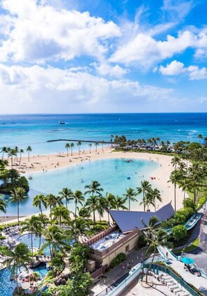 A resort with a beach, pool area, and ocean view.