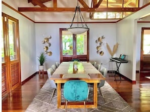 Enjoy meals with friends and family in this spacious dining area, surrounded by natural light and decorative art pieces.