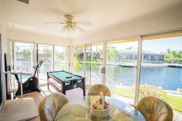 Patio with a dining table, a game table and an exercise bike.