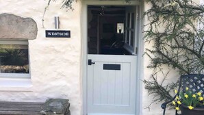 A white door with a black handle and a nameplate reading "WESTSIDE."