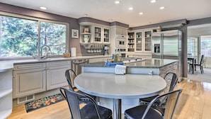 A modern kitchen with a central island, built-in appliances, and ample counter space. - Near Shops & Eats! Centennial Home w/ Sunroom (Centennial)