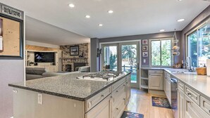 A modern kitchen with a large island, built-in appliances, and a view to the outdoors. - Near Shops & Eats! Centennial Home w/ Sunroom (Centennial)