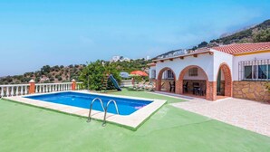 A swimming pool with a slide, a covered patio area, and a view of a hillside. - Villa Marín Canillas de Aceituno by Ruralidays (Málaga)