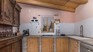 A kitchen with wooden cabinets, a built-in stove, a microwave, and a Bosch dishwasher. - Istrian Tavern with Shared Pool (Banjole)