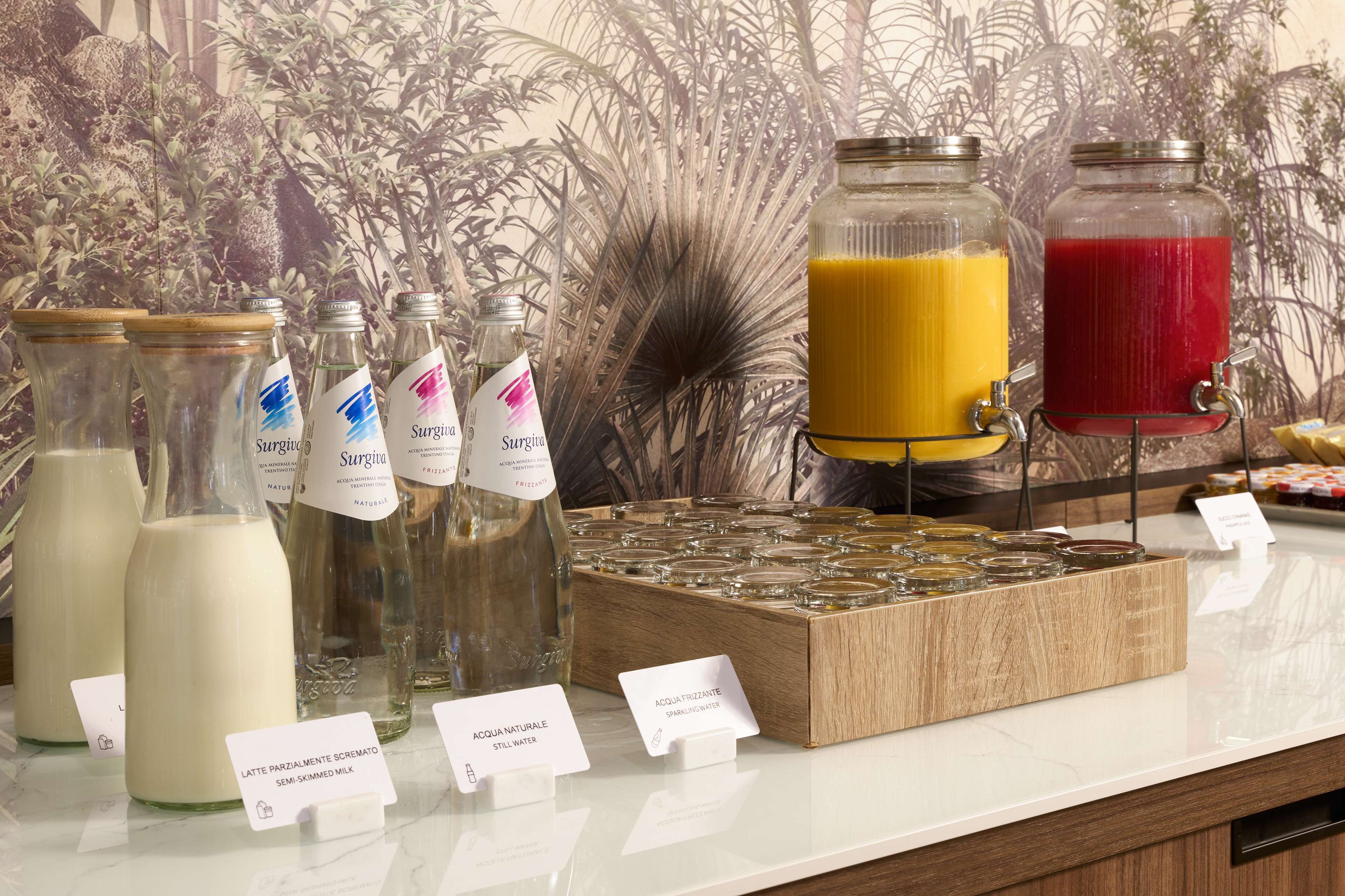 A beverage station with milk, juice, and sparkling water options.