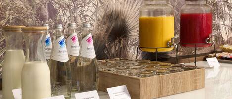 A beverage station with milk, juice, and sparkling water options.