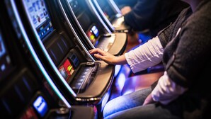 A person using a slot machine in a casino. - Bonney Lake House INN  W/Jacuzzi and Centralized AC (Bonney Lake)