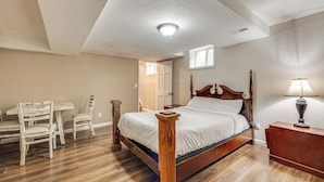 A bedroom with a wooden bed, a desk, and chairs. - Family-Friendly Home 2 Mi to Dtwn Colorado Springs (Colorado Springs)