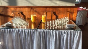 A table set with multiple glasses and a large pitcher, likely for a beverage service. - Hostería Cotopaxi Tour (Tanicuchi)