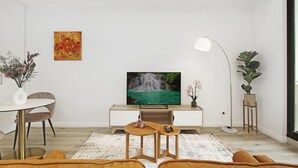 A modern living room with a flat-screen TV, a dining table, and two chairs. - Experience serenity in this modern haven
Train/Ferry to City~Shops~Parking (Ryde)
