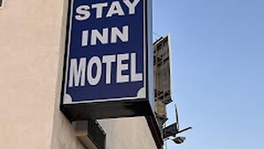 A sign for a motel with the text "STAY INN MOTEL". - Stay Inn Motel (Harbor City)