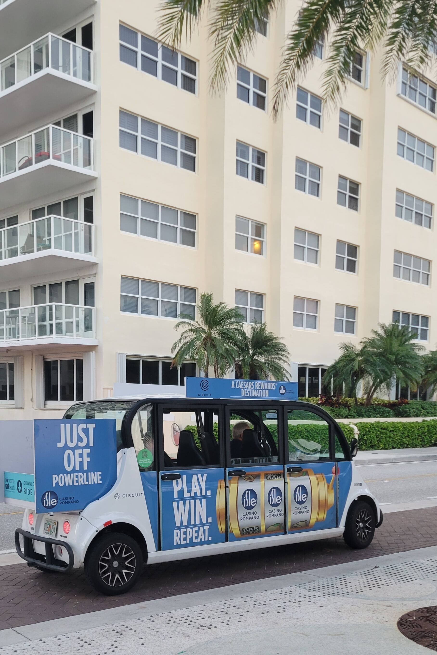 A promotional vehicle with advertisements for Isle Casino Pompano and a Caesars Rewards Destination sign.