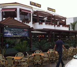 Café Pizza and Restaurant offers outdoor seating with wicker tables and chairs.