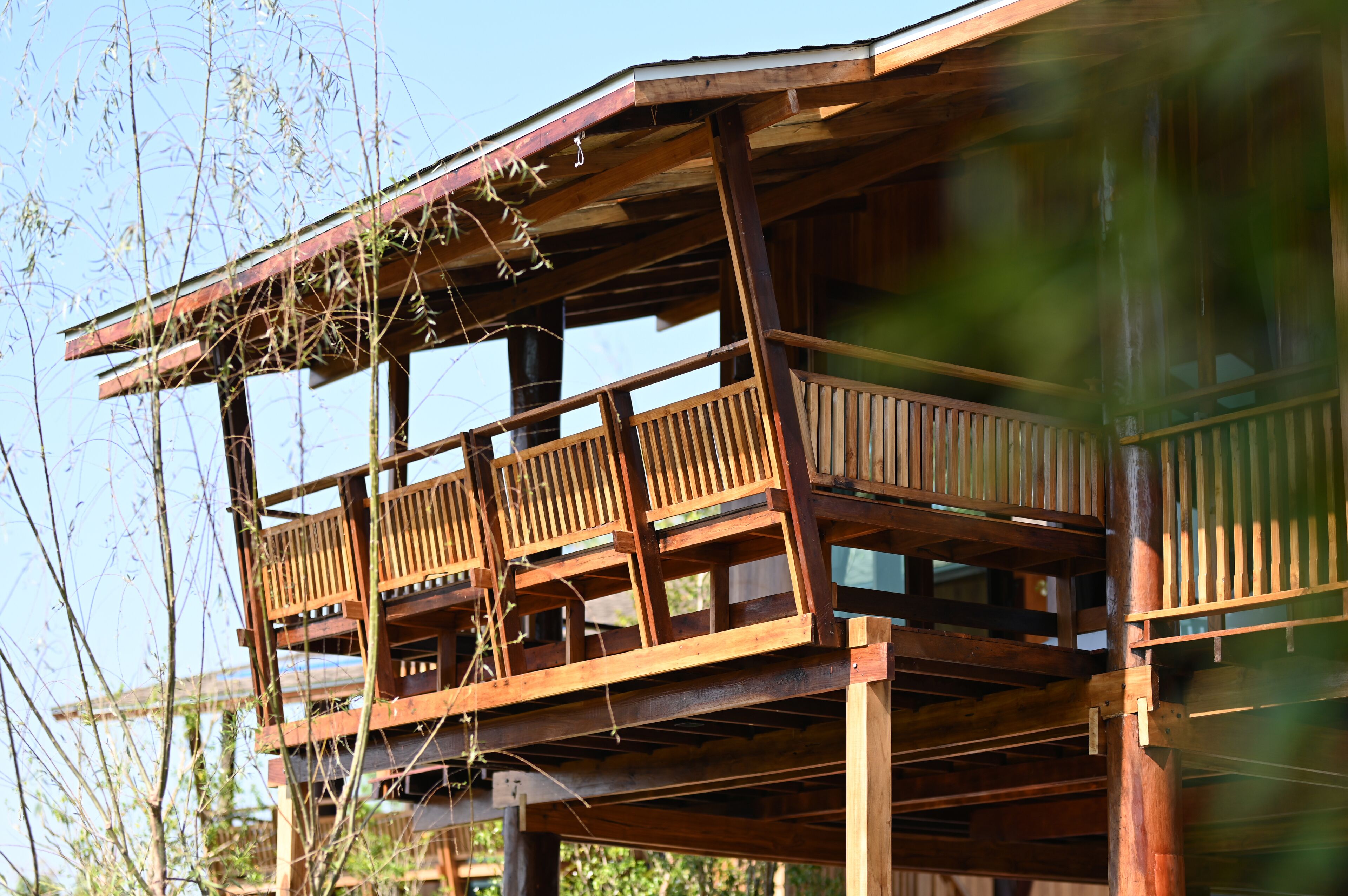A wooden balcony structure with railings and a wooden floor.