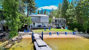 A two-story house with a deck and outdoor seating, located near a body of water. - Almost Heaven-Lakefront-Shared dock w/Annie's Place-Rent both for a 6-room getaway for large groups! (McCall)