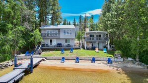 A two-story house with a deck and outdoor seating, located near a body of water. - Annie's Place-Lakefront-Shared dock w/Almost Heaven-Rent both for a 6-room getaway for large groups! (McCall)
