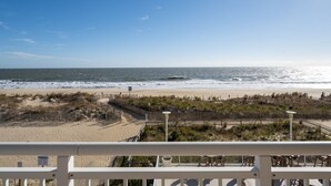 A beach view with a wooden fence, a pathway, and a lamp post. - Luxurious 4 bedroom oceanfront condo in the most prestigious building in OC, (Ocean City)
