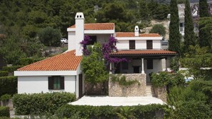A two-story house with a tiled roof, white walls, and a stone foundation. - 5 Bedroom Villa, Pool, Sea Views, Baska Voda (Baska Voda)