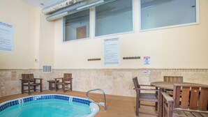 A hot tub facility with a pool, wooden chairs, and a table. - Amazing Copper Mountain Views, free wifi, free parking. (Copper Mountain)