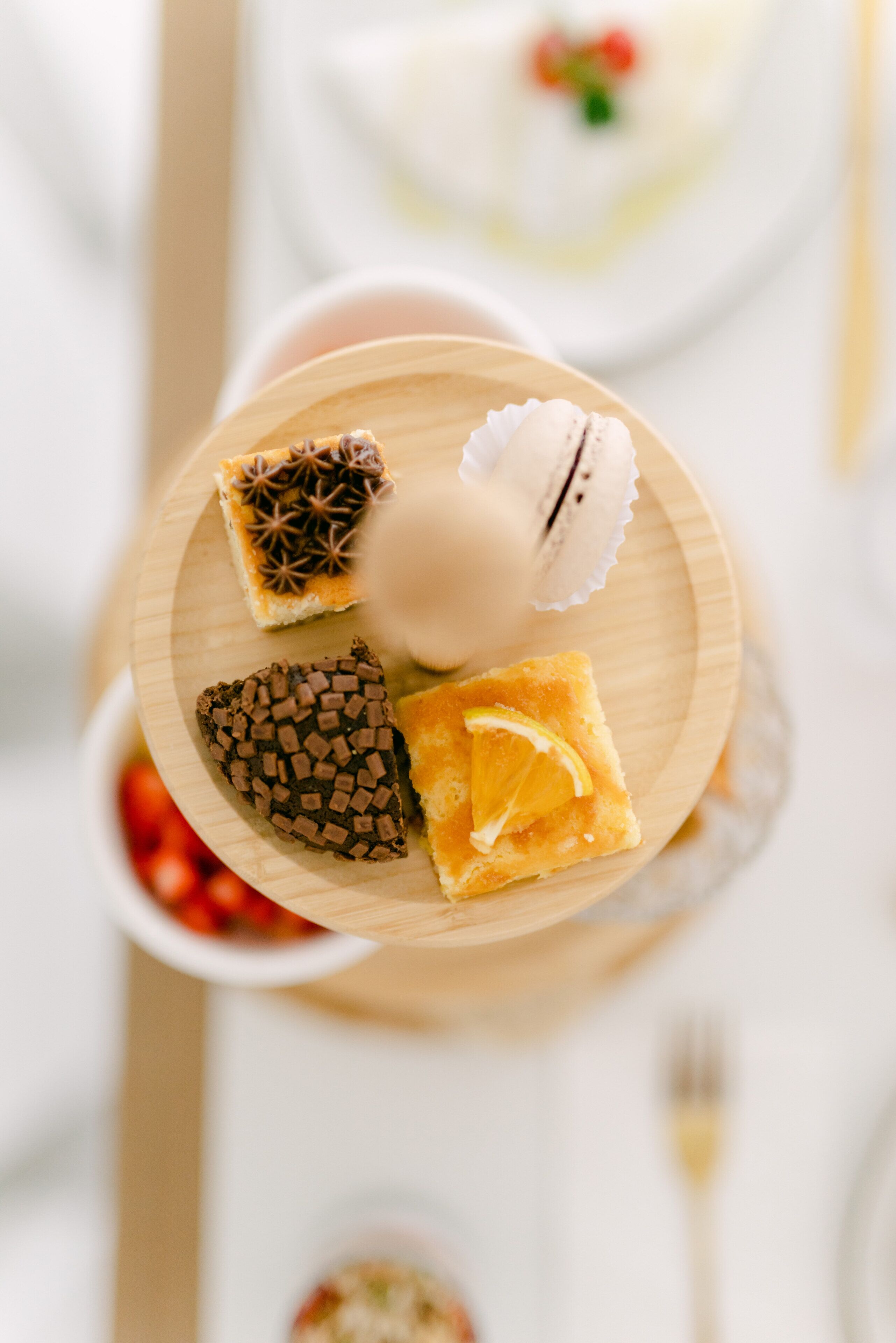 A dessert plate with various sweets and a slice of lemon.