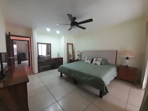 A bedroom with a bed, bedside tables, a ceiling fan, and a desk. - Beautiful New Casita-Ajijic West 360 Degree View of Lake/Mountains (Ajijic)