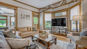 A spacious living room with a sofa, coffee table, and TV.