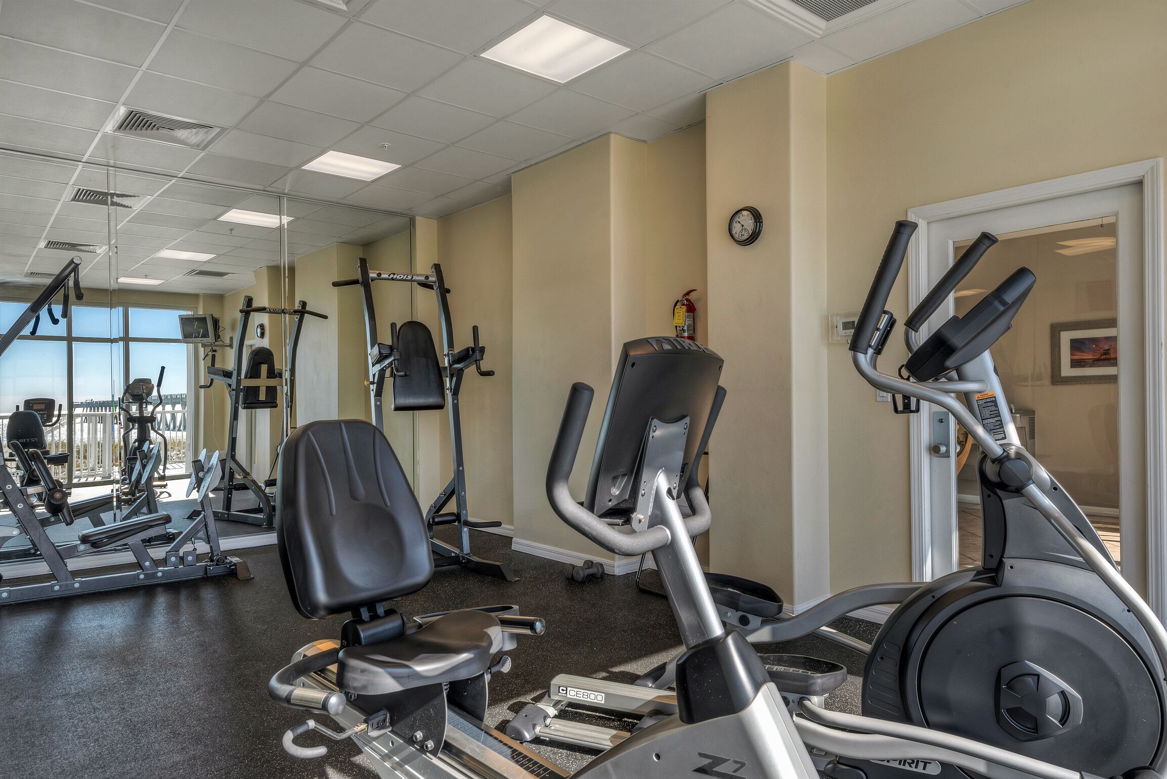 A gym with various exercise equipment, including treadmills and weight machines.