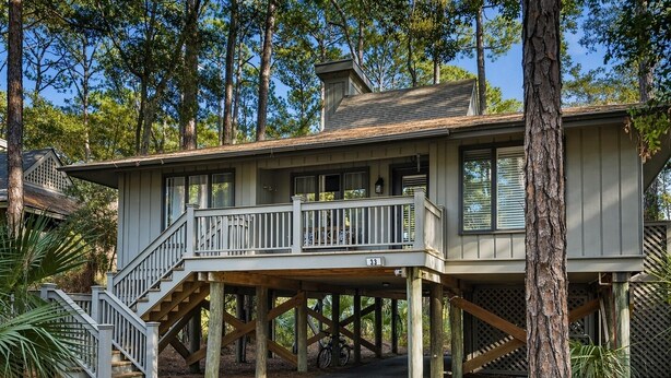 A two-story house with a balcony, a staircase, and a number 33 sign. - Pet Friendly, Walk to beach, pool and community dock and more! (Kiawah Island)