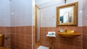 Un baño con inodoro, lavabo y ducha.