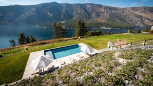 A swimming pool with a view of a lake and mountains. - Private Pool | Stunning lake & mountain views | Modern, costal design (Manson)