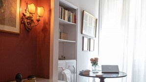 A room with a white dresser, a bookshelf, a table with a laptop, and a chair. - ELEGANT COZY 2BD IN SANTA CROCE - FLORENCE (FIRENZE)