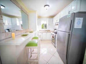 Fridge, cookware/dishes/utensils, dining tables