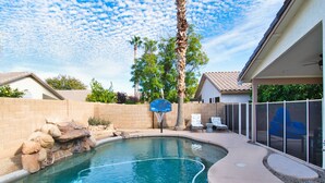 A backyard with a swimming pool, a basketball hoop, and a covered seating area. - Gilbert Ranch Retreat & Non Heated Pool. Walk to Shops and Restaurants. (Gilbert)