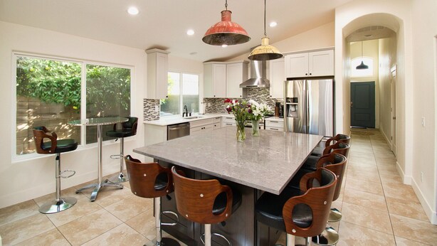 A spacious kitchen with a large island, modern appliances, and a view of the outdoors. - Gilbert Ranch Retreat & Non Heated Pool. Walk to Shops and Restaurants. (Gilbert)