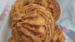 A container with several pastries, possibly a type of bread or pastry, placed inside.