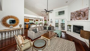 A spacious living room with a sectional sofa, a coffee table, and a fireplace.