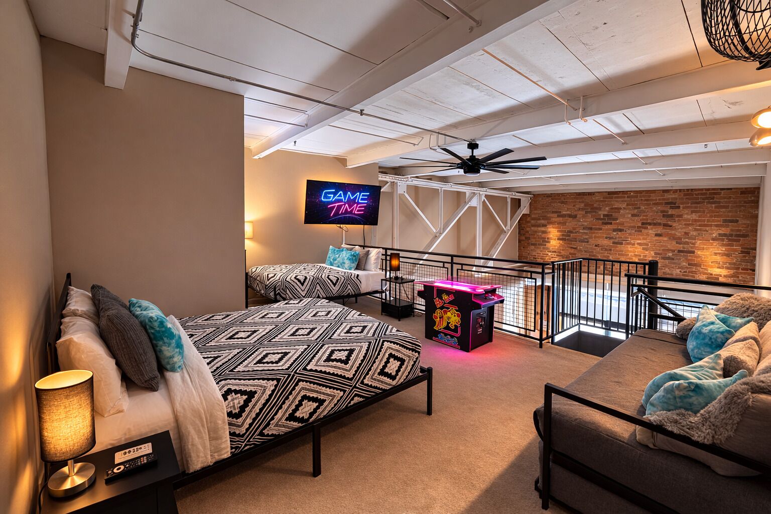 A modern room with a bed, a sofa, a gaming table, and a TV displaying 'GAME TIME'.
