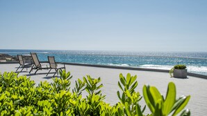 A rooftop terrace with a view of the ocean, featuring lounge chairs and potted plants. - VillaPlayaEncantada-Pools&BeachAccess-Rosarito (Rosarito)