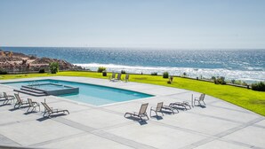 A pool with lounge chairs and a view of the ocean. - VillaPlayaEncantada-Pools&BeachAccess-Rosarito (Rosarito)