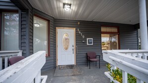 A house with a front door, a mailbox, and a number '1419' on the wall. - Top of Tacoma Flat Unit 1 (Tacoma)