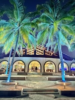 A hotel with arched windows and a central fountain.