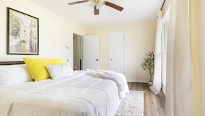 A bedroom with a bed, a ceiling fan, a door, and a plant. - Centally located w/ coffee bar, theatre/gameroom (Orangeburg)