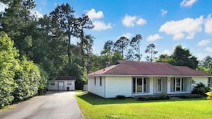 A single-story house with a red roof, a garage, and a well-maintained lawn. - Centally located w/ coffee bar, theatre/gameroom (Orangeburg)