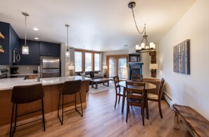 Enjoy meals at the central island with bar stools, or dine at the round table with comfortable seating.